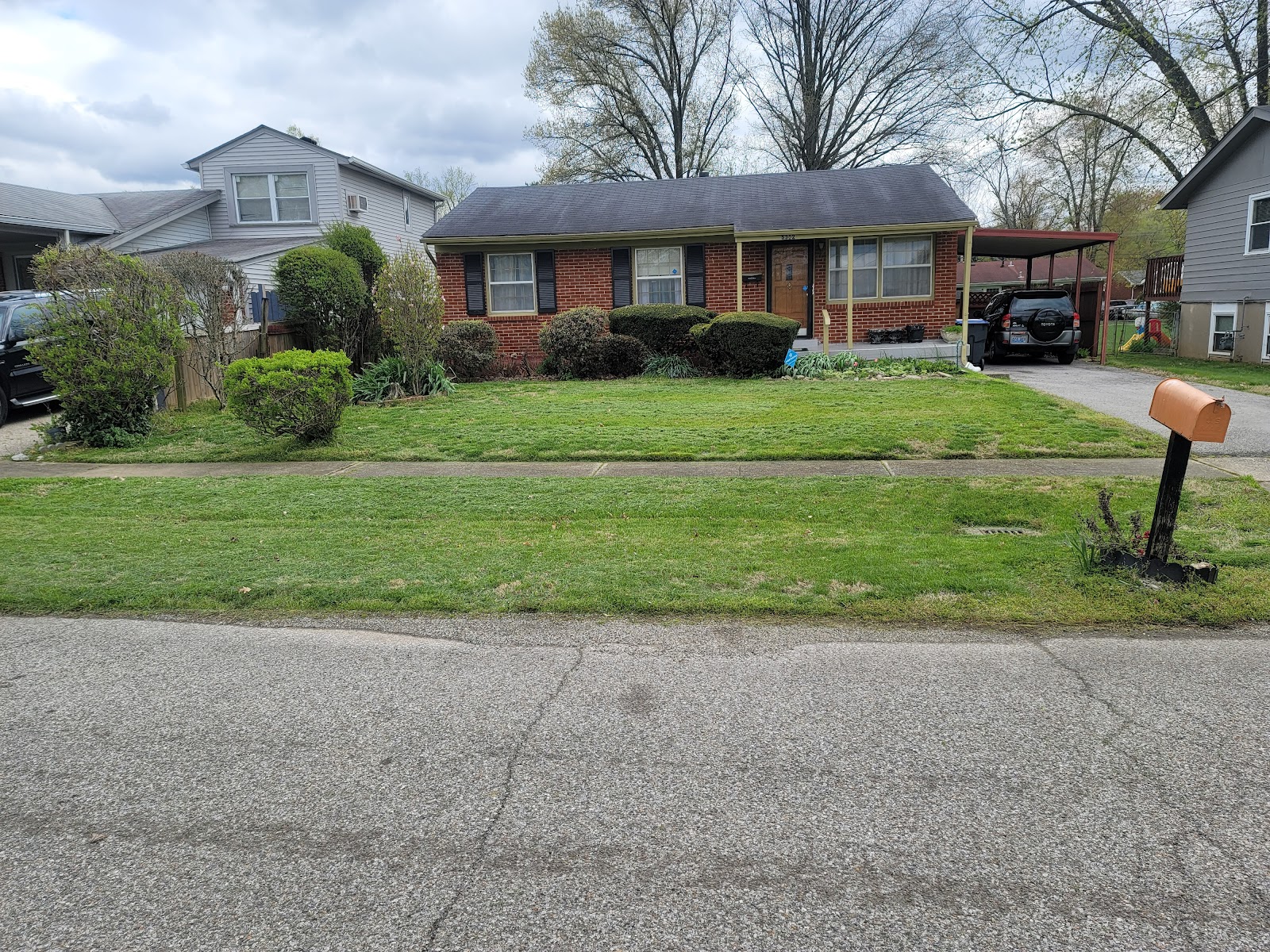 Maintained lawn and trimmed landscaping at a local residential property